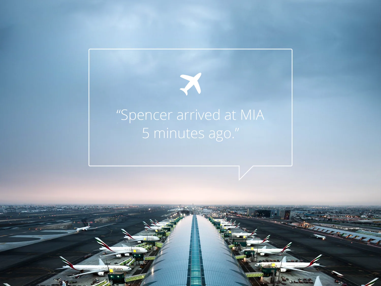 Airport at dusk with a message reading Spencer arrived at MIA five minutes ago